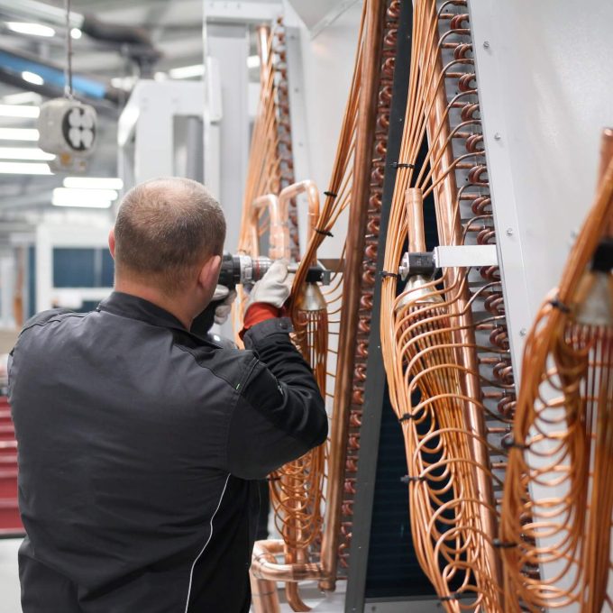 Refrigeration factory worker, assembling cooling systems at Refra production facilities in Lithuania
