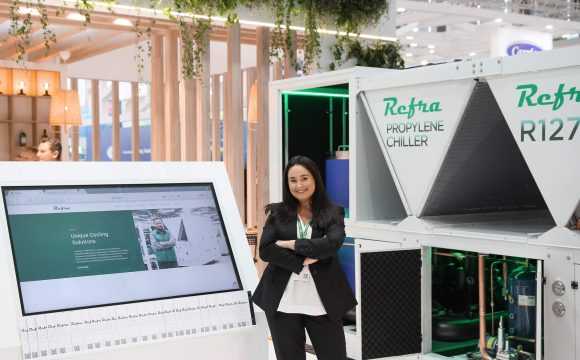 A woman in a black suit, standing at Refra stand in Chillventa trade show for refrigeration and air conditioning