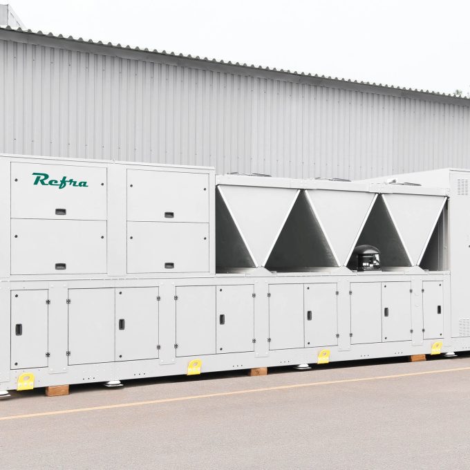 Hybrid industrial refrigeration chiller with integrated water system, produces by Refra, standing outdoors, front view.